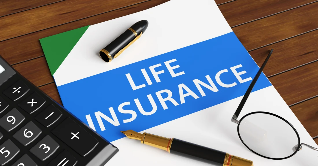 Calculator, glasses, and life insurance paper